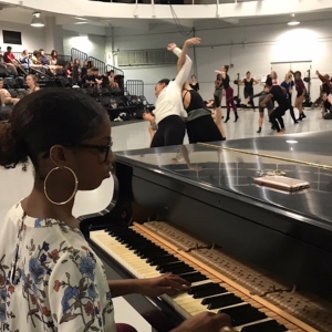 A pianist plays while dancers rehearse in the studio