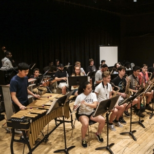 A jazz band rehearses on stage