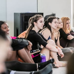 Dancers sit in the studio and have a discussion