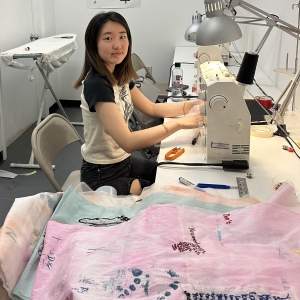 student working on project at sewing machine