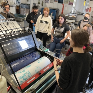Faculty member giving students an overview of offset printing