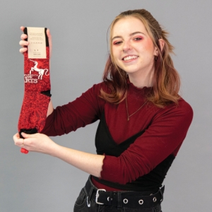 holly janson showing off the socks she designed. 